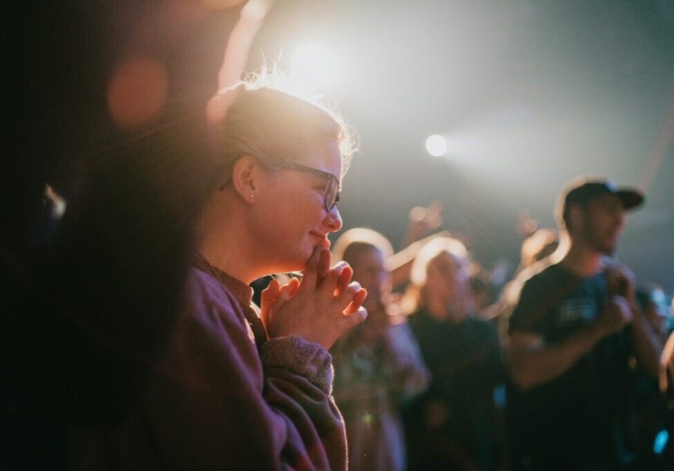 selective focus photography of woman praying